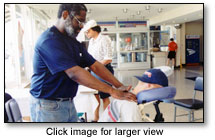 David Crawford gives a chair massage to a worker in the company lounge, a great monthly benefit for employees.